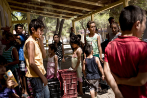 Syrian children waiting for lunch this month at a refugee camp southeast of Athens, Greece. (NYT)